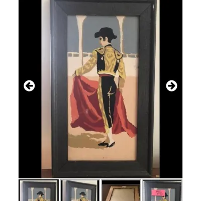 Framed mid-century paint-by-number or print depicting a matador in traditional dress, set in a simple black wooden frame.