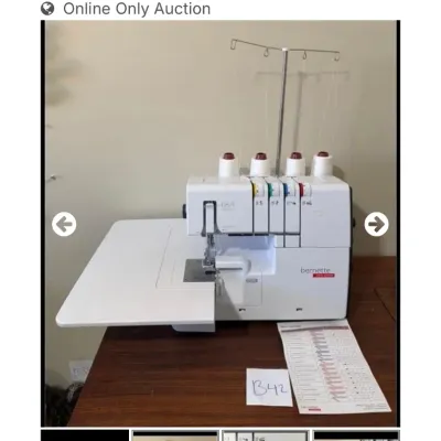 Sale Photo Thumbnail #54: Bernette Funlock b64 AIRLOCK overlocker machine featuring an extension table, four spools of white thread, and thread tension guide.