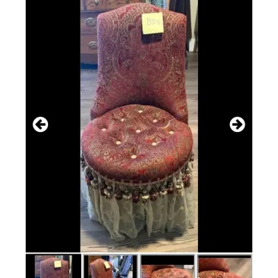 Sale Photo Thumbnail #24: Vintage boudoir chair upholstered in a red-and-gold paisley brocade pattern with a tufted seat, tassel fringe trim, and a sheer lace dust skirt.
