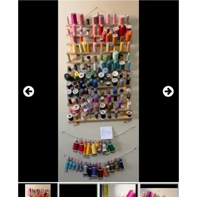 Sale Photo Thumbnail #55: Large collection of colorful sewing thread spools organized on wooden wall racks and hanging displays.