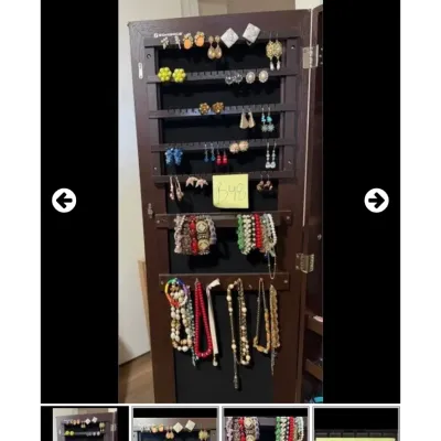 Sale Photo Thumbnail #47: Standing dark wood jewelry armoire filled with various costume jewelry, including earrings, bracelets, and beaded necklaces.