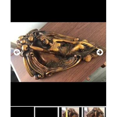 Art Nouveau style molded gold-toned wall sconce or shelf bracket featuring a reclining female figure surrounded by fruit and floral motifs.