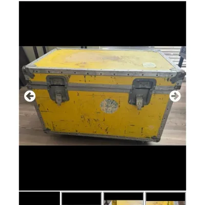 Sale Photo Thumbnail #95: Heavy-duty yellow flight case with reinforced metal corners and butterfly latches, showing heavy cosmetic wear and distressing.