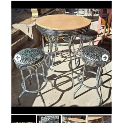 Sale Photo Thumbnail #52: Retro-style pub height bistro table with a chrome frame and four matching zebra-patterned vinyl swivel stools.