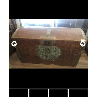 Sale Photo Thumbnail #22: Antique wooden dome-top trunk featuring hand-painted lettering and the date 1812 inside a circular medallion on the front panel.