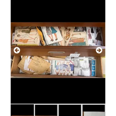 Sale Photo Thumbnail #60: Large collection of vintage sewing patterns from brands like McCall's, Butterick, and Simplicity, stored inside wooden cabinet drawers.