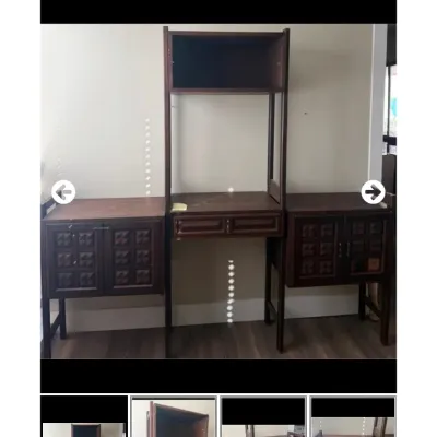 Sale Photo Thumbnail #94: Vintage dark wood modular wall unit featuring carved grid-pattern cabinet doors, a central desk section with drawers, and an upper shelf.