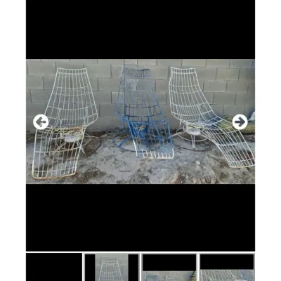 Sale Photo Thumbnail #38: Set of three vintage mid-century wrought iron wire mesh patio lounge chairs with circular swivel bases.