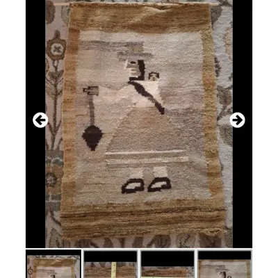 Hand-woven Andean or Southwestern textile wall hanging depicting a stylized figure carrying a child on their back. Crafted in...
