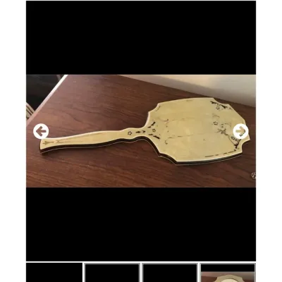 Sale Photo Thumbnail #41: Vintage celluloid vanity hand mirror featuring an inlaid floral motif on the reverse side.