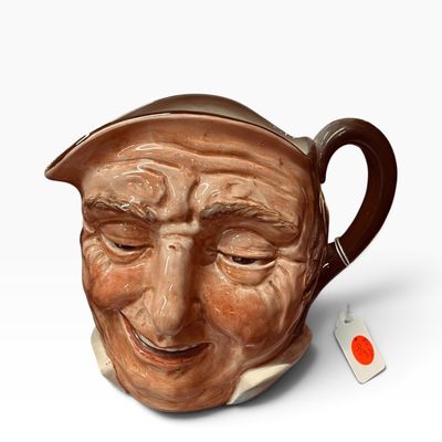 Sale Photo Thumbnail #24: Vintage ceramic character Toby jug featuring a detailed, smiling man's face with a brown handle and spout.