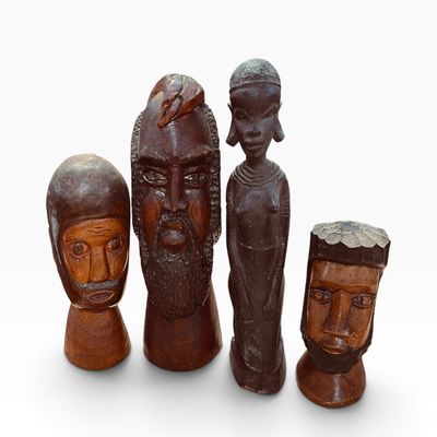 Collection of four vintage hand-carved wooden sculptures, including three busts and one full-length African figure, featuring rich dark...