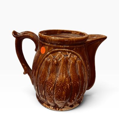 Sale Photo Thumbnail #25: Vintage brown majolica glazed ceramic pitcher featuring a detailed relief design of hanging fish.