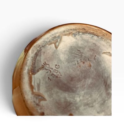 Underside of a ceramic vessel featuring an impressed maker's mark and model number 488G.