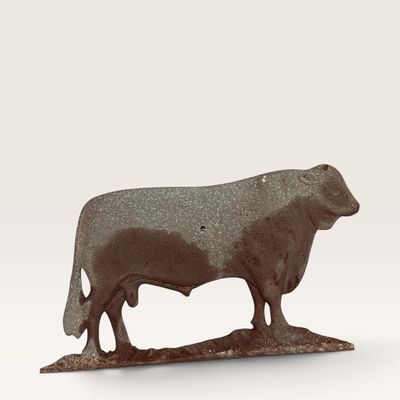 Vintage cast metal bull silhouette figurine with a weathered dark finish.