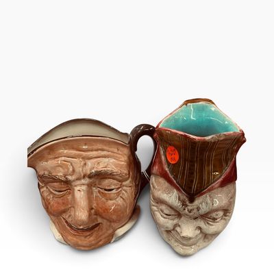 Pair of vintage character Toby jugs featuring sculpted facial details and glossy glazed finishes.