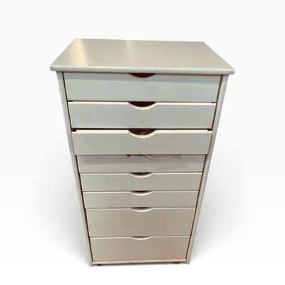 White IKEA Alex style eight-drawer storage cabinet, featuring cutout handles and showing minor scuffs and surface wear.