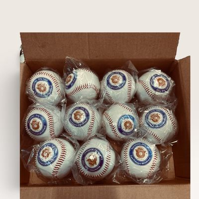 Cardboard box filled with individually plastic-wrapped Smokey Bear promotional baseballs.