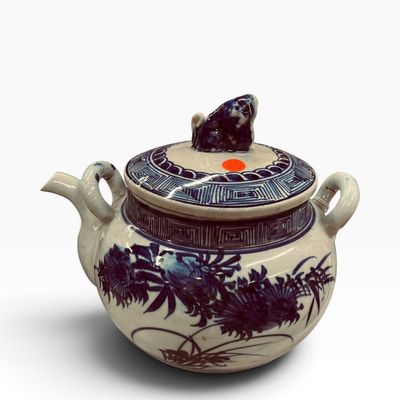 Sale Photo Thumbnail #26: Vintage Asian blue and white porcelain teapot featuring hand-painted floral motifs and a sculpted animal finial on the lid.