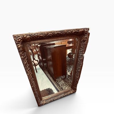 Large ornate rectangular wall mirror featuring a heavily detailed gold-finished frame with floral and acanthus leaf carvings.