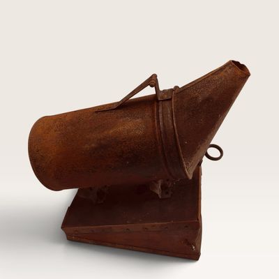 Antique rusty metal beekeeper smoker tool featuring a cylindrical fuel canister, nozzle, and bellow base.