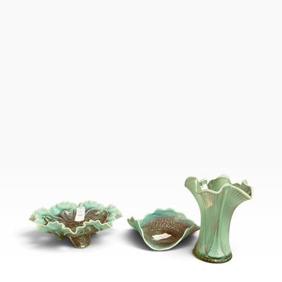 Sale Photo Thumbnail #44: Collection of three light green and brown majolica pottery pieces, including a ruffled vase and two decorative footed dishes.