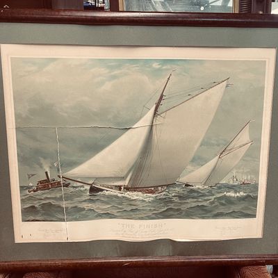 Sale Photo Thumbnail #13: Framed vintage maritime print titled "The Finish," depicting an 1885 yacht race, with visible creases and wear to the paper and wood frame.