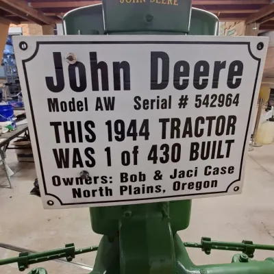 Sale Photo Thumbnail #4: Vintage 1944 John Deere Model AW tractor, featuring a custom informational display sign mounted to the front.