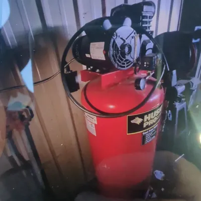 Sale Photo Thumbnail #2: Husky Pro upright air compressor featuring a red tank and top-mounted electric motor.