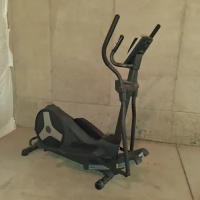 Sale Photo Thumbnail #647: THIS IS LOCATED IN THE BASEMENT 
GOLD'S GYM STRIDE TRAINER ELLIPTICAL MACHINE. FEATURES ADJUSTABLE STRIDE, DIGITAL DISPLAY CONSOLE WITH WORKOUT PROGRAMS, BUILT-IN FAN, RESISTANCE CONTROLS, AND HEART RATE GRIPS. LIGHT SURFACE DUST AND PREVIOUS USE WEAR VIS