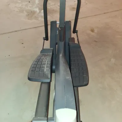 Sale Photo Thumbnail #651: THIS IS LOCATED IN THE BASEMENT 
GOLD'S GYM STRIDE TRAINER ELLIPTICAL MACHINE. FEATURES ADJUSTABLE STRIDE, DIGITAL DISPLAY CONSOLE WITH WORKOUT PROGRAMS, BUILT-IN FAN, RESISTANCE CONTROLS, AND HEART RATE GRIPS. LIGHT SURFACE DUST AND PREVIOUS USE WEAR VIS