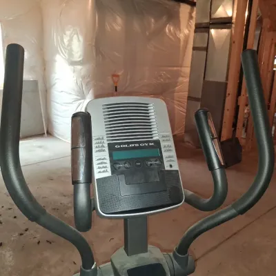 Sale Photo Thumbnail #652: THIS IS LOCATED IN THE BASEMENT 
GOLD'S GYM STRIDE TRAINER ELLIPTICAL MACHINE. FEATURES ADJUSTABLE STRIDE, DIGITAL DISPLAY CONSOLE WITH WORKOUT PROGRAMS, BUILT-IN FAN, RESISTANCE CONTROLS, AND HEART RATE GRIPS. LIGHT SURFACE DUST AND PREVIOUS USE WEAR VIS