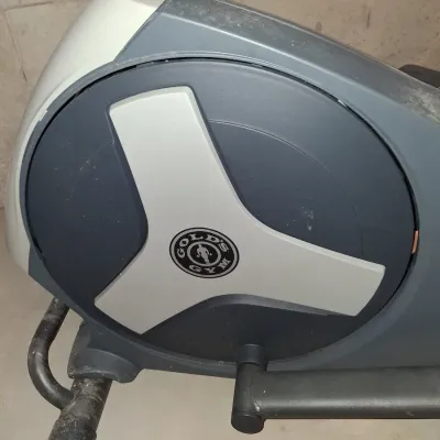 Sale Photo Thumbnail #648: THIS IS LOCATED IN THE BASEMENT 
GOLD'S GYM STRIDE TRAINER ELLIPTICAL MACHINE. FEATURES ADJUSTABLE STRIDE, DIGITAL DISPLAY CONSOLE WITH WORKOUT PROGRAMS, BUILT-IN FAN, RESISTANCE CONTROLS, AND HEART RATE GRIPS. LIGHT SURFACE DUST AND PREVIOUS USE WEAR VIS