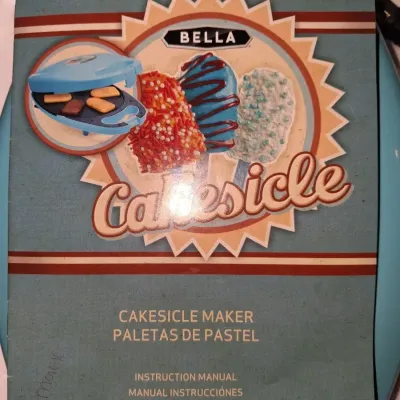 Sale Photo Thumbnail #684: BELLA CAKESICLE MAKER IN ORIGINAL TIN LUNCHBOX STYLE STORAGE BOX. INCLUDES MAKER, INSTRUCTION MANUAL, DECORATING SYRINGE TOOL, STICKS AND MORE. APPEARS LIGHTLY USED OR UNUSED IN ORIGINAL PACKAGING.