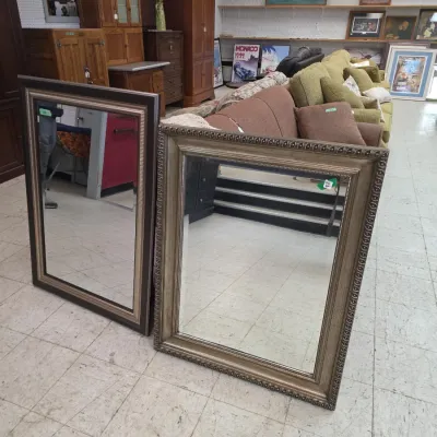 Sale Photo Thumbnail #16: Two large rectangular wall mirrors with molded wooden frames displayed in a retail or showroom setting.
