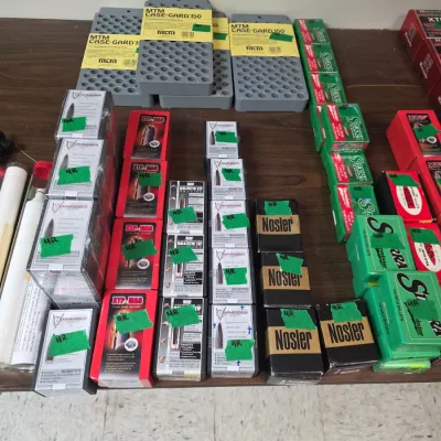 Sale Photo Thumbnail #89: Assortment of bullet reloading supplies, including boxes of Nosler, Sierra, and XTP-MAG bullets alongside MTM Case-Gard loading trays.
