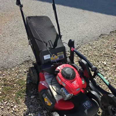 Sale Photo Thumbnail #145: Craftsman M210 red self-propelled gas lawn mower with attached grass catcher bag, featuring a 150cc Briggs & Stratton engine.