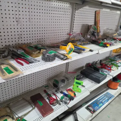 Sale Photo Thumbnail #106: Retail shelving packed with an assortment of hand tools, hardware, wire wheels, and workshop accessories.