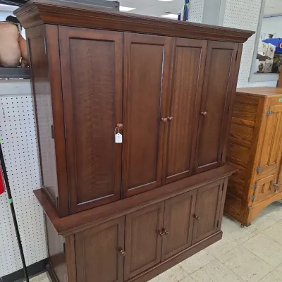 Sale Photo Thumbnail #17: Large wooden cabinet or hutch with dark stain finish, featuring multi-door storage cabinets on both the upper and lower sections.