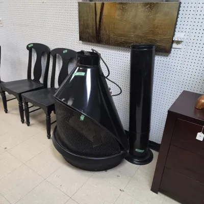 Sale Photo Thumbnail #30: Mid-century modern cone fireplace with black finish and matching chimney pipe, displayed alongside dining chairs and a two-panel abstract wall art piece.