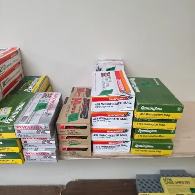 Sale Photo Thumbnail #90: Selection of boxed rifle ammunition, including Winchester, Remington, and Hornady brands in .458 Winchester Mag, .416 Remington Mag, and .35 Rem calibers.