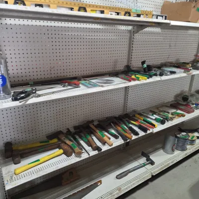 Sale Photo Thumbnail #105: Assorted hand tools displayed on retail shelving, including hammers, saws, levels, chisels, and rulers.