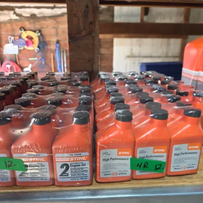 Sale Photo Thumbnail #126: Multiple shrink-wrapped six-packs of Stihl 2-cycle high-performance engine oil bottles, 6.4 fl. oz. size.
