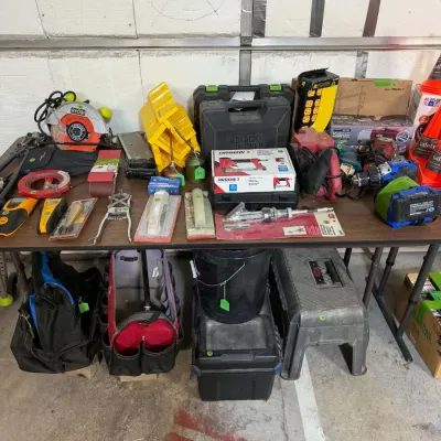 Sale Photo Thumbnail #33: Assorted power and hand tools, including a Ryobi circular saw, Black & Decker tool cases, Arrow stapler, and various tool bags.