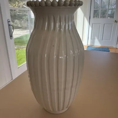 Sale Photo Thumbnail #37: Tall white glazed ceramic floor or table vase featuring a ribbed, fluted body and a beaded trim around the rim.