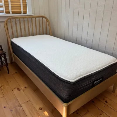 Sale Photo Thumbnail #28: Twin-size wooden bed frame featuring a spindle headboard, fitted with a Beautyrest Hybrid mattress.
