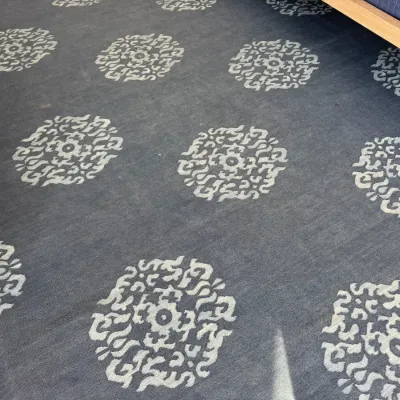 Sale Photo Thumbnail #52: Large dark grey wool area rug featuring a repeating white Asian-inspired medallion pattern, shown laid out on hardwood floors.