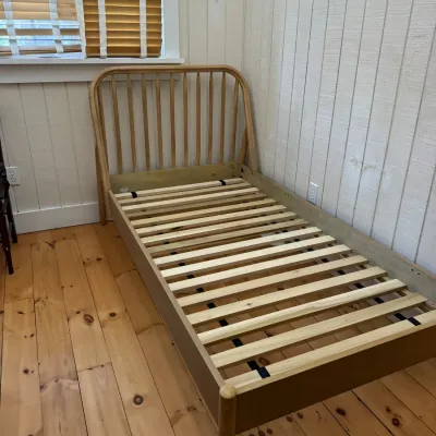 Sale Photo Thumbnail #27: Light wood twin bed frame featuring a spindle headboard and wooden slat base.