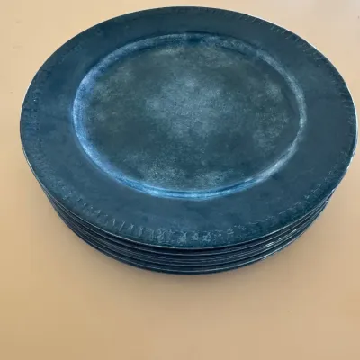 Sale Photo Thumbnail #60: Stack of antique pewter plates with a distressed patina and subtle rim detail.