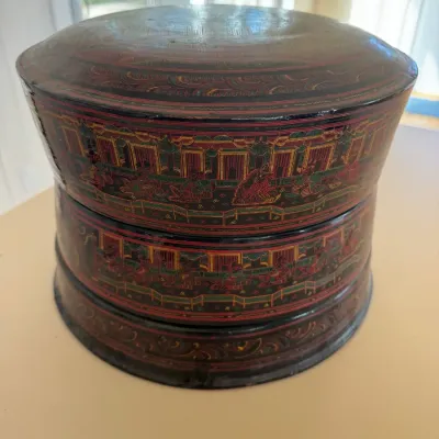 Sale Photo Thumbnail #40: Traditional Burmese lacquerware stacked round container featuring intricate red, green, and gold etched court scenes.